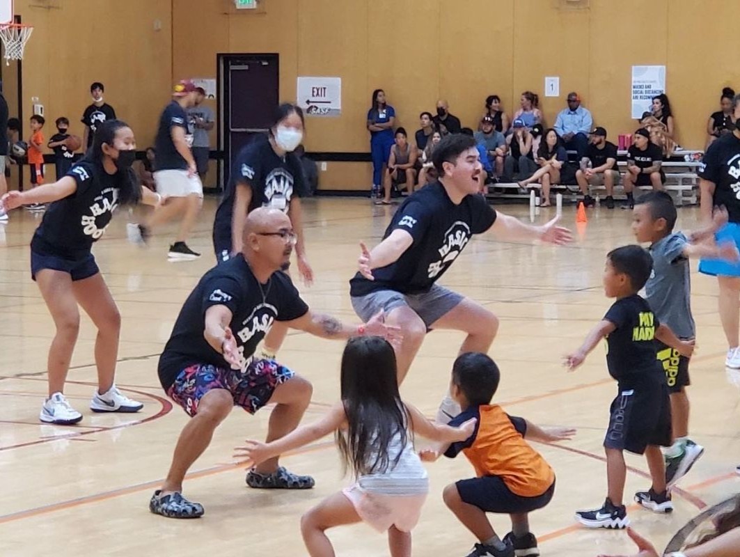Basketball coaches teaching players how to play defense.